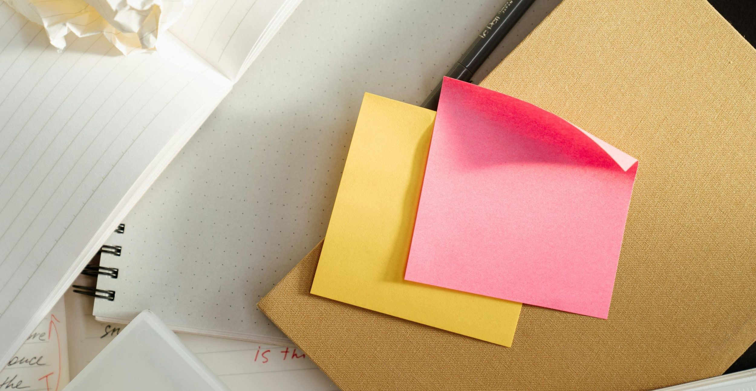 Image of desk with a laptop and post-it notes to represent the custom itinerary planning process. Photo by: cottonbro studio