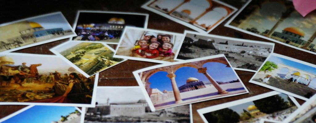 Flatlay of photos featuring travel experiences. Photo by Akh Taufiq