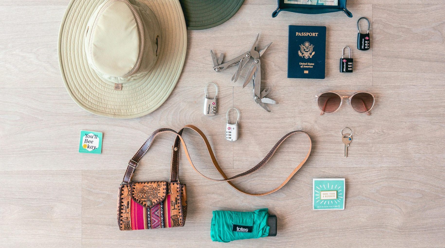 Overhead photo of items laid out depicting travel packing list essentials. Photo by Hana Brannigan