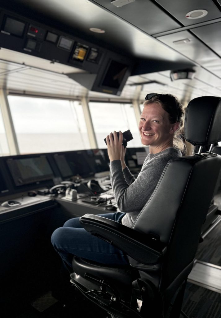 Arctic or Antarctica? The author is pictured on the bridge of the ship in the Arctic holding a pair of binoculars. 
